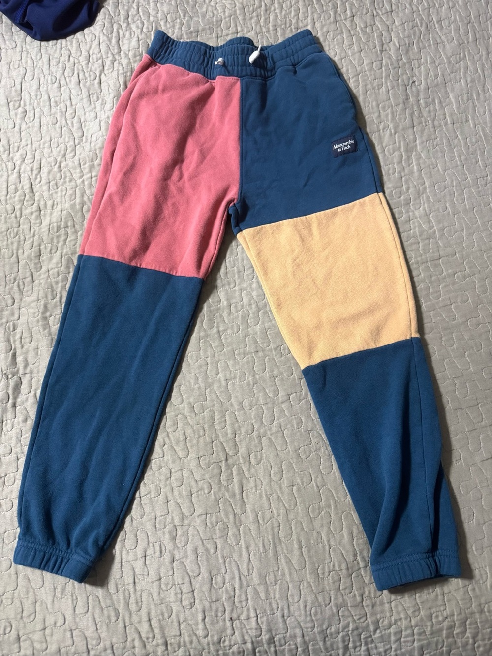 Abercrombie Kids boys color-block fleece sweatpants featuring panels of pink